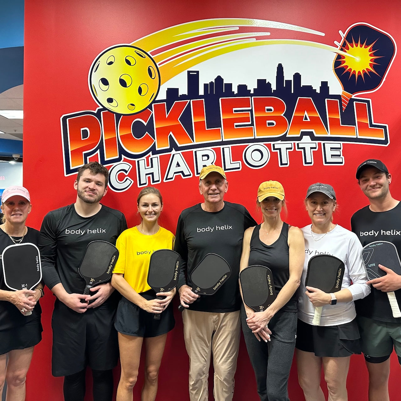 body helix community in front of Pickleball charlotte sign