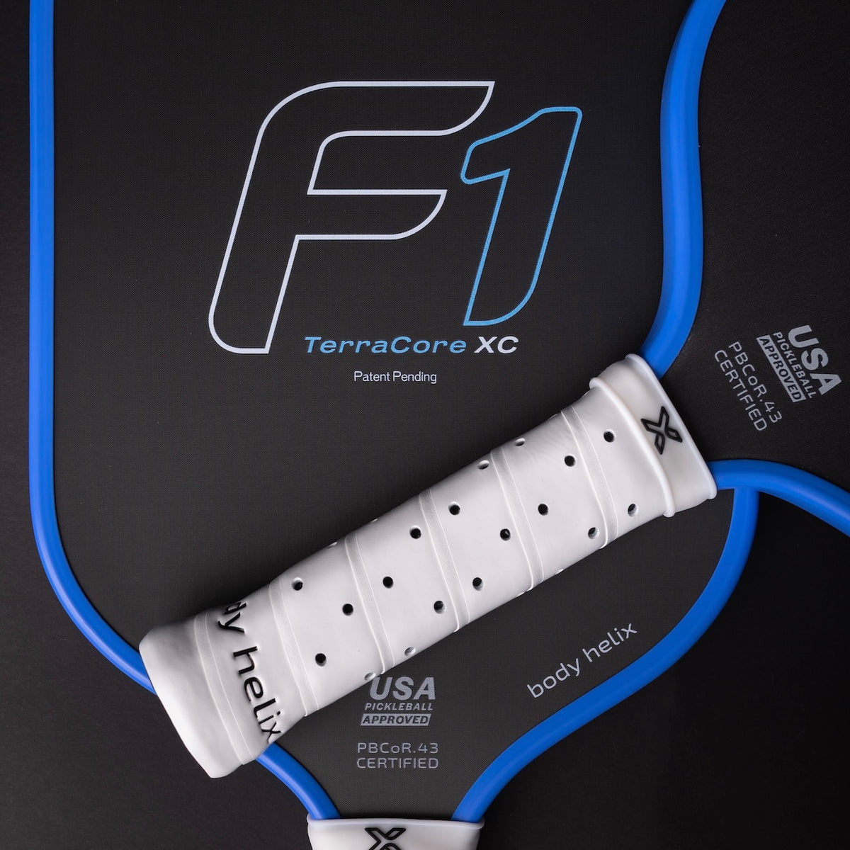 Close-up of a pickleball paddle with 'F1 TerraCore XC' branding on a black background.