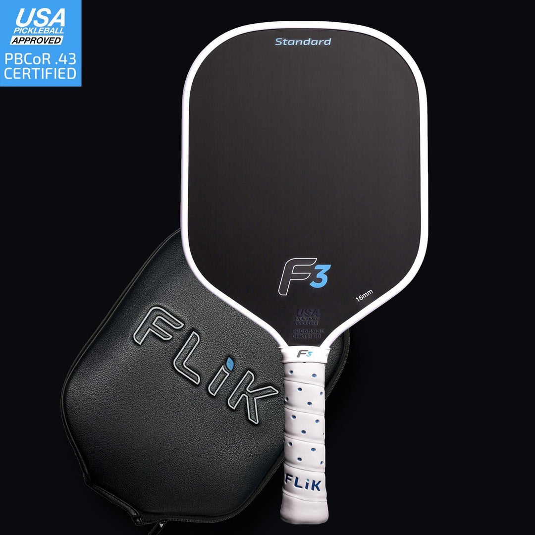 Black pickleball paddle with white accents and a black carrying case on a dark background