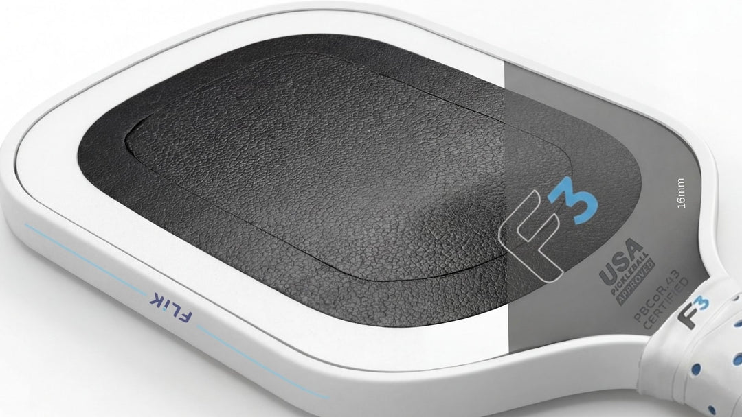 Close-up of a pickleball paddle with F3 branding on a white background