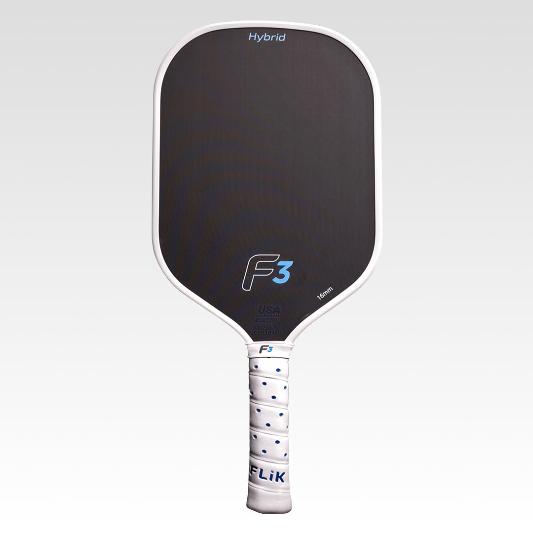 A FLiK pickleball paddle with a black paddle face, white frame, and a white wrapped handle and branding, shown against a light gray gradient background.