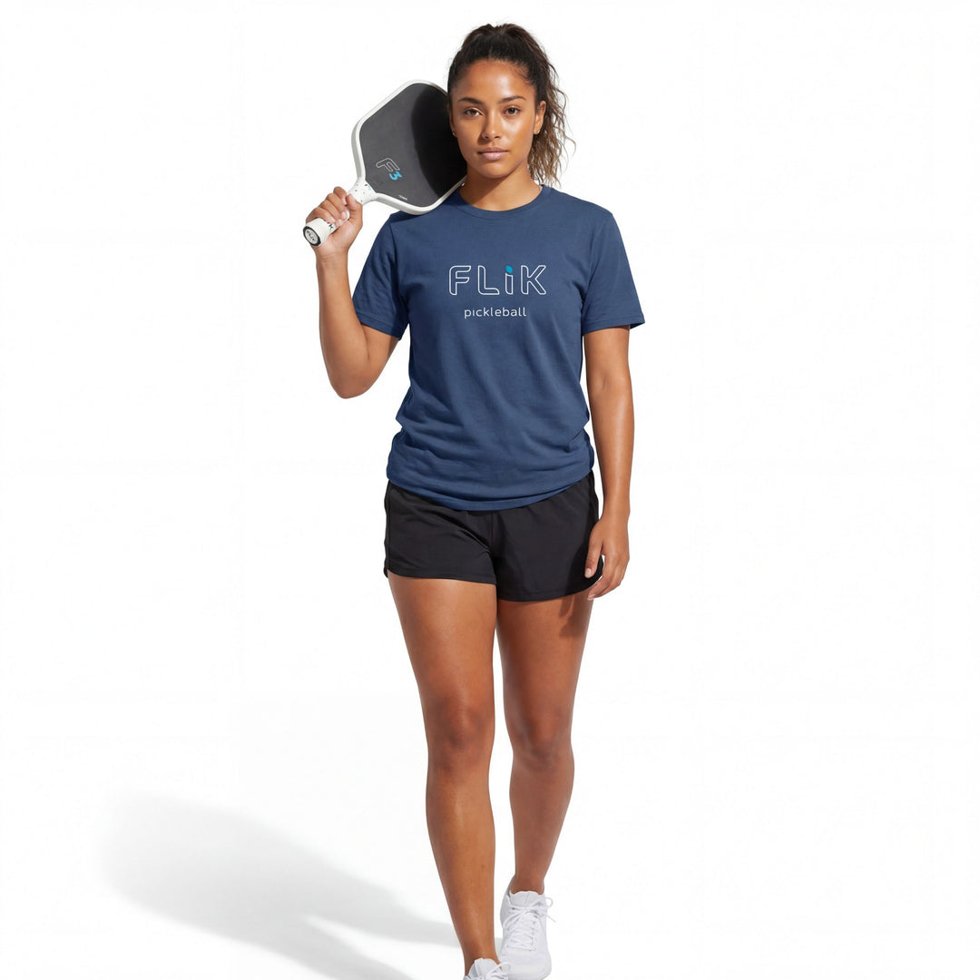 Woman holding a pickleball paddle wearing a blue 'Flik' t-shirt on a white background
