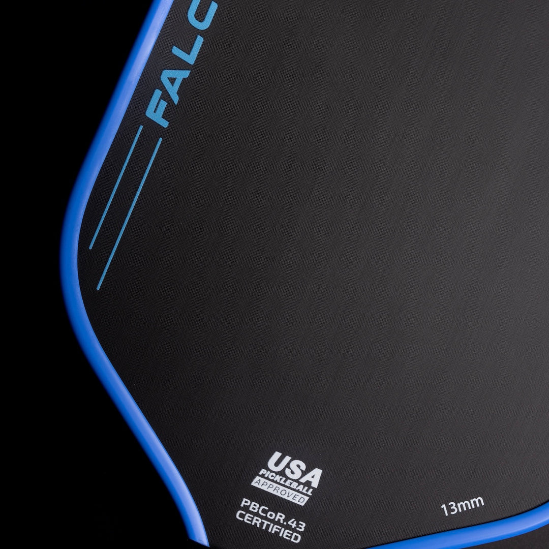 Black and blue mouse pad with 'Falcon' branding and certification details on a black background