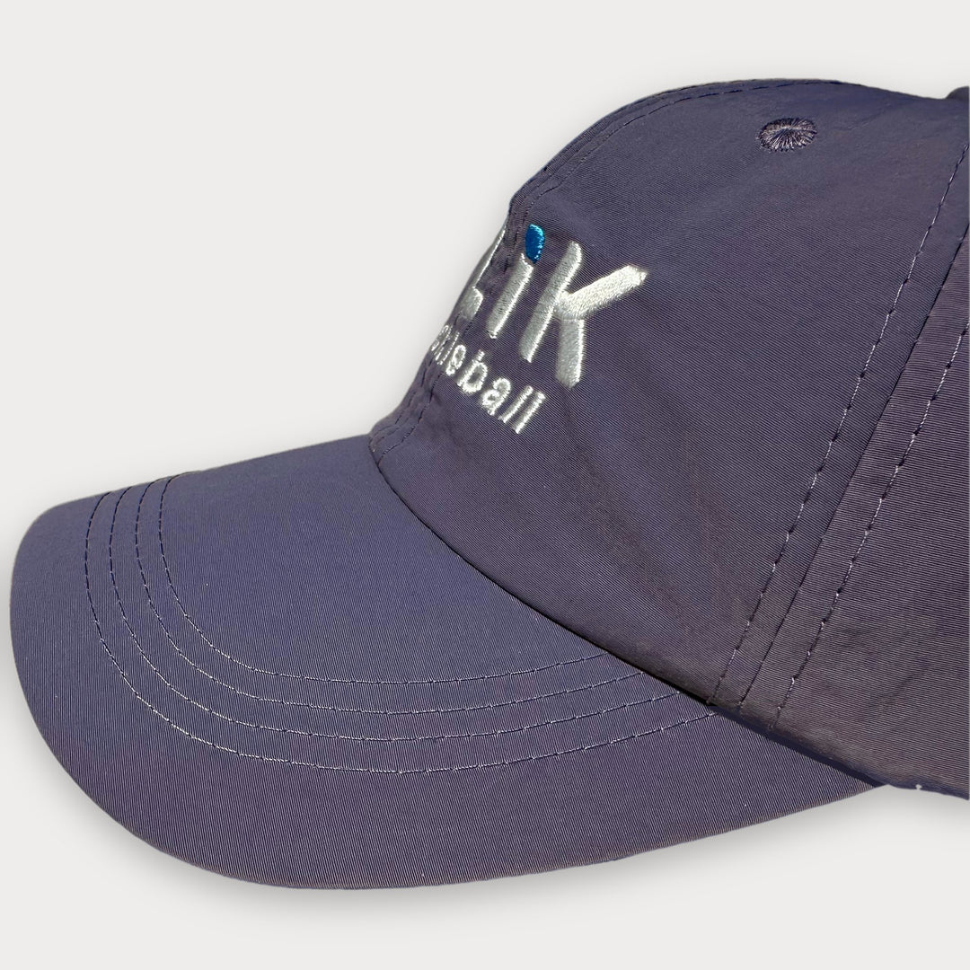 A close-up shot of a purple baseball cap with white embroidered text reading &